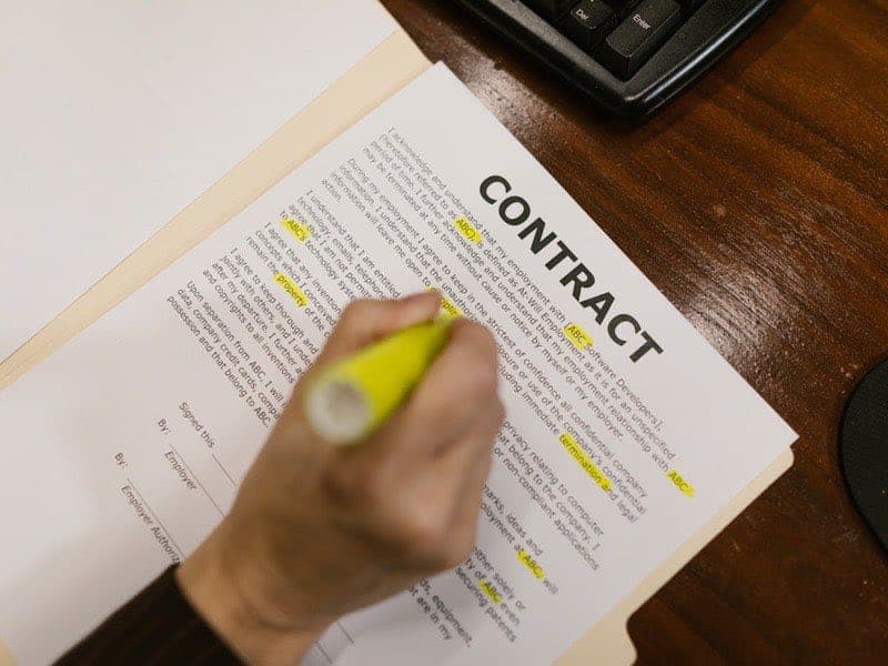 Professional reviewing contract documents at a desk