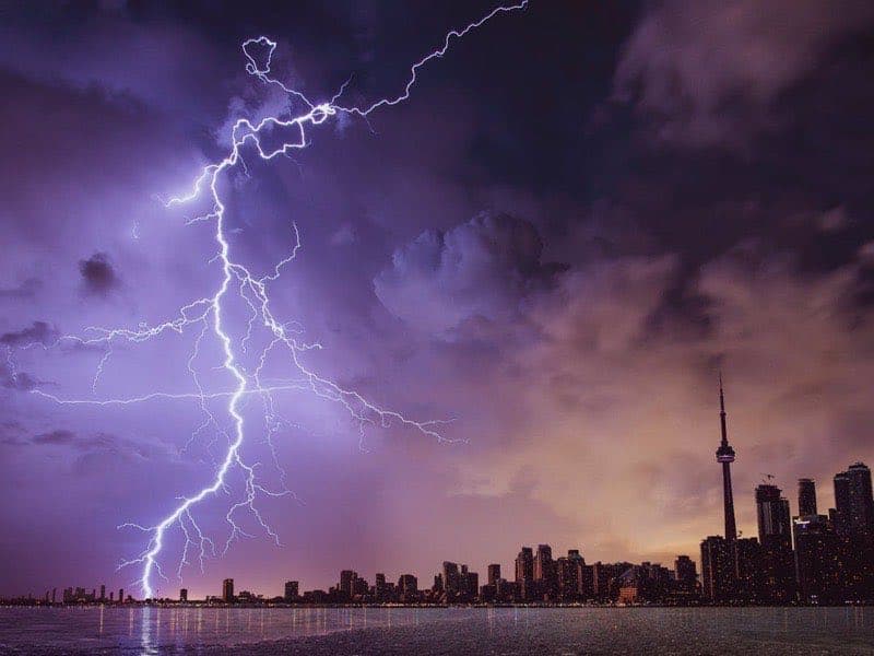 Dark storm clouds gathering over buildings